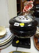 A black ceramic grave side urn complete with liner