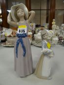 Two Lladro figures - child holding pig & girl in bonnet