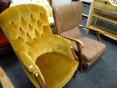 A vintage button backed armchair together with another vintage oak framed armchair