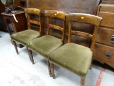 Three Edwardian curved back cushion seated dining chairs