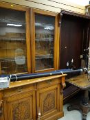 Early twentieth century bookcase-cupboard together with a modern reproduction mahogany bookshelf