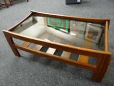 A retro G-plan bow-frame smoky glass Long John coffee table with slatted lower shelf