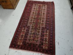 A black & red patterned Baluchi prayer rug, 155 x 88cms
