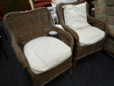 A pair of wicker conservatory-style armchairs together with two painted white spindleback kitchen