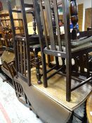 A vintage oak drop leaf & gate-legged dining table together with a set of four matching splat back