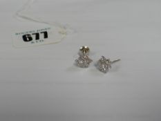 A pair of 18ct diamond cluster earrings (one scroll only)