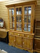 A pine mirror backed display cabinet on a three-drawer & cupboard base