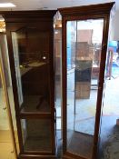 A vintage tall darkwood display cabinet together with a reproduction dark wood two section tall