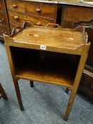 A nineteenth century open shelved gallery topped bedside cabinet