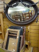 An ornately decorated oval bevelled glass wall mirror together with a parcel of various picture