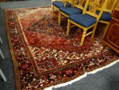A large fine quality red & black patterned tribal woollen rug from Iran,330 x 258cms
