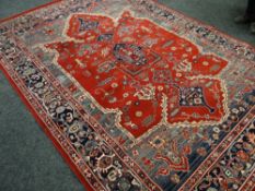 A large vintage patterned woollen rug, 198 x 286cms together with a similar large circular patterned