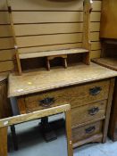 A light oak Arts & Crafts-style three-drawer dressing table