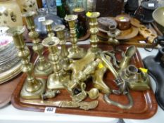 Tray of various brassware including candle holders, letter opener, novelty pair of Edwardian