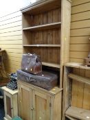 A narrow pine cupboard bookcase