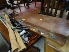 A vintage brown leather carry case, a collection of walking sticks including shooting stick,