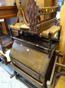 A vintage sloped top two-drawer bureau together with a long rush topped stool, magazine rack, wine