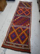 A bright red, green blue geometric pattern Suzni Killam runner, 241 x 73cms