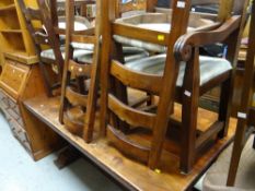 A modern chunky hardwood refectory dining table together with six ladder backed matching chairs with