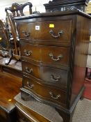 A small reproduction mahogany serpentine chest of four drawers