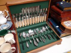 A vintage wooden cased canteen of cutlery