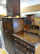 A vintage Priory-style linenfold bedroom suite comprising two-door wardrobe, dressing table, chest