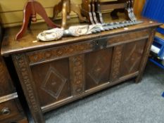 An antique oak carved three-panelled fronted coffer, circa 1800 Height - 76cms, depth - 58cms,