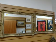 A pair of modern gilt framed bevelled wall mirrors