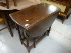 A vintage oak barley-twist drop leaf small dining table