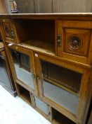 An early twentieth century oak partially glazed & cupboard wall unit