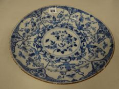 An eighteenth century English Delft charger with floral & insect decoration in under glazed blue