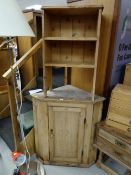 A vintage pine hanging corner cupboard together with a small pine bookcase