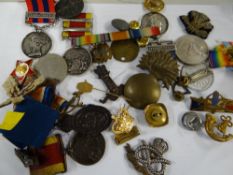 Box containing four replica Victorian medals, various military badges & medal ribbons etc