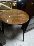An antique oak cricket style table