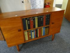 A vintage drinks / cocktail cabinet with a revolving centre disguised as a bookcase