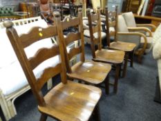 A set of four rustic oak ladderback dining chairs
