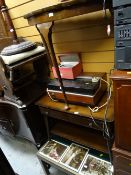 A small glass topped brass edge coffee table containing collection of cinema lobby cards from the