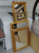 A parcel of four various sized modern pine framed mirrors