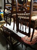 A modern reproduction dark wood extending dining table with barley-twist decoration to edge by