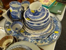 A large blue & white charger, various blue & white plates, mugs etc