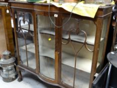 A vintage bow fronted three-section glass door mahogany railback display cabinet on raised ball &