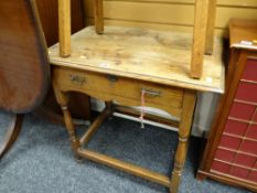 An antique oak side table with single drawer