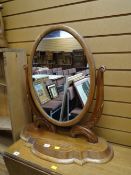 An ornate mahogany shaped toilet mirror
