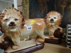 A pair of vintage Staffordshire ceramic lions