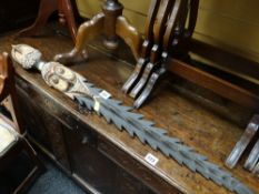 A carved tribal ceremonial staff-type weapon