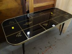 A retro black & gold long-John coffee-table, circa 1960s