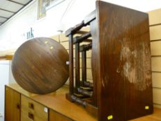 Dark wood nest of three tables and a circular occasional table