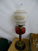 Victorian oil lamp with cranberry glass font and later shade