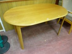 Oval light wood dining table