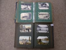 Two albums of vintage postcards and photographs